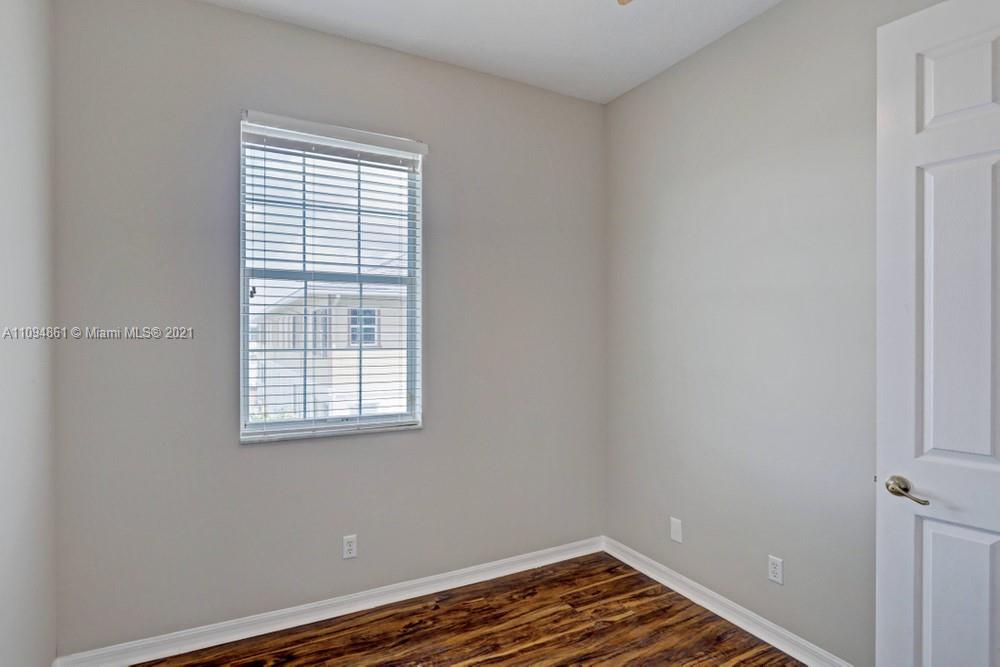 1541 Frederick Small Road, Unit 1541 Jupiter, FL 33458 - Photo 35 of 56 a view of room with window and wooden floor