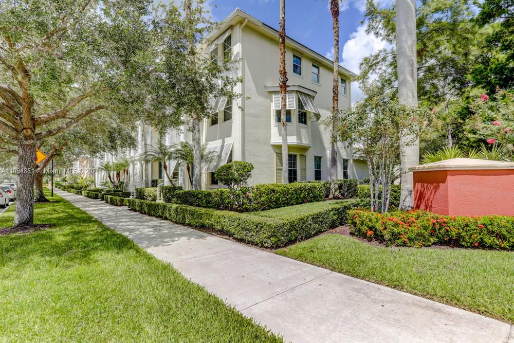 1541 Frederick Small Road, Unit 1541 Jupiter, FL 33458 - Photo 4 of 56 a view of a large brick building next to a yard
