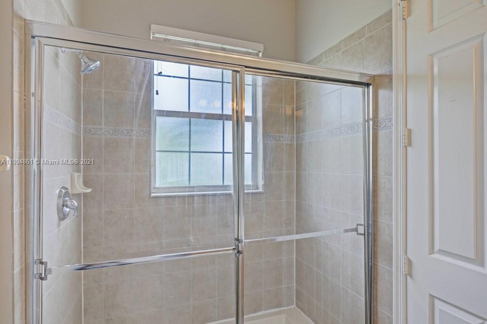 1541 Frederick Small Road, Unit 1541 Jupiter, FL 33458 - Photo 46 of 56 a bathroom with a glass shower door
