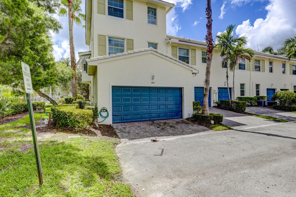 1541 Frederick Small Road, Unit 1541 Jupiter, FL 33458 - Photo 53 of 56 a view of a white house with a yard