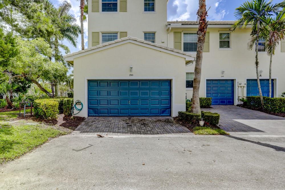 1541 Frederick Small Road, Unit 1541 Jupiter, FL 33458 - Photo 54 of 56 a view of a house with a yard and garage