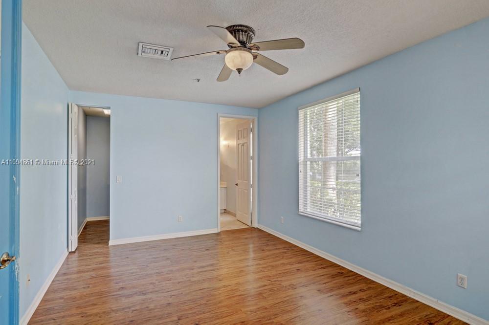 1541 Frederick Small Road, Unit 1541 Jupiter, FL 33458 - Photo 7 of 56 wooden floor in an empty room with a window