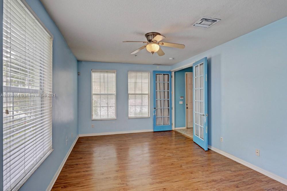 1541 Frederick Small Road, Unit 1541 Jupiter, FL 33458 - Photo 8 of 56 a view of an empty room with a window and wooden floor