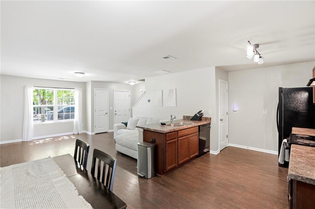 244 Sidney Lanier Avenue Athens, GA 30607 - Photo 11 of 32 a large white kitchen with a stove top oven a sink a dining table and chairs