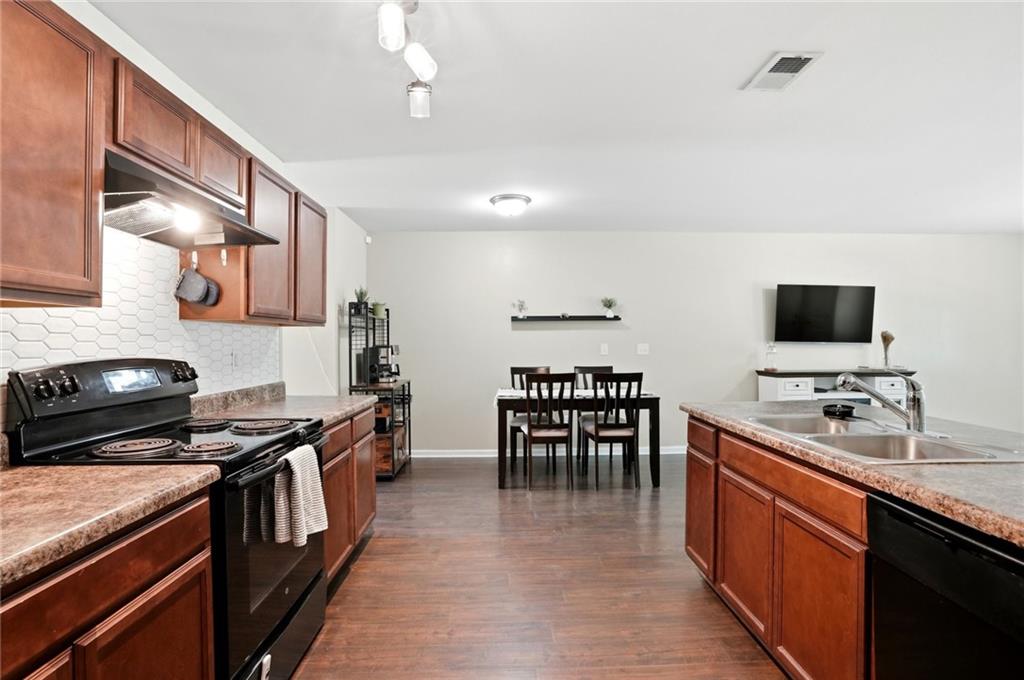 244 Sidney Lanier Avenue Athens, GA 30607 - Photo 10 of 32 a kitchen with stainless steel appliances stove top oven dining table and chairs