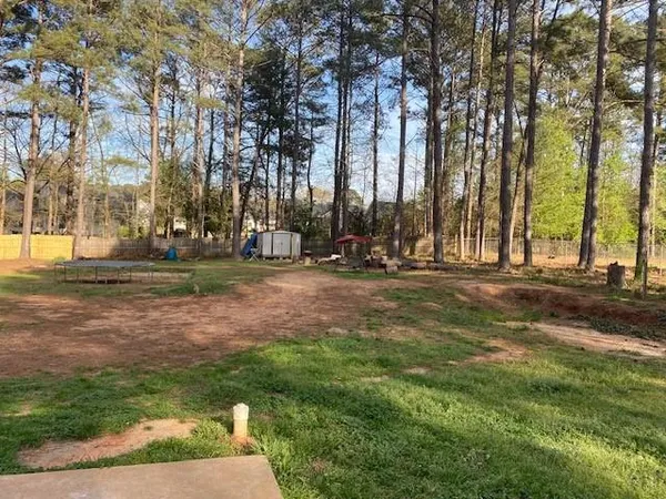 a backyard of a house with lots of green space and fountain