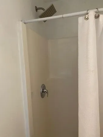 a bathroom with a shower and a tub