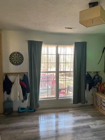 a bed room with furniture and a wooden floor