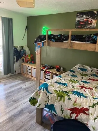 a view of a hallway with wooden floor and closet