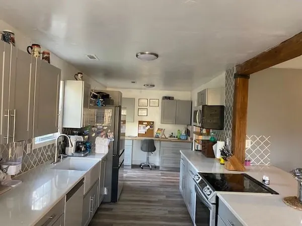 a kitchen with counter top space a sink cabinets and appliances