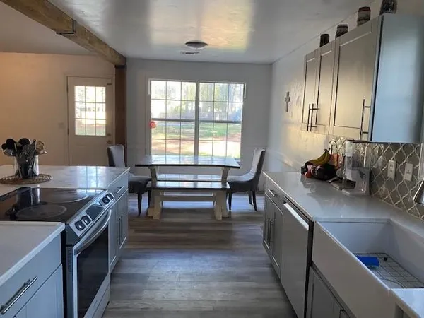 a kitchen with a sink and a stove top oven