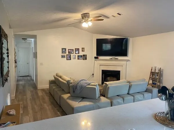 a living room with furniture fireplace and flat screen tv