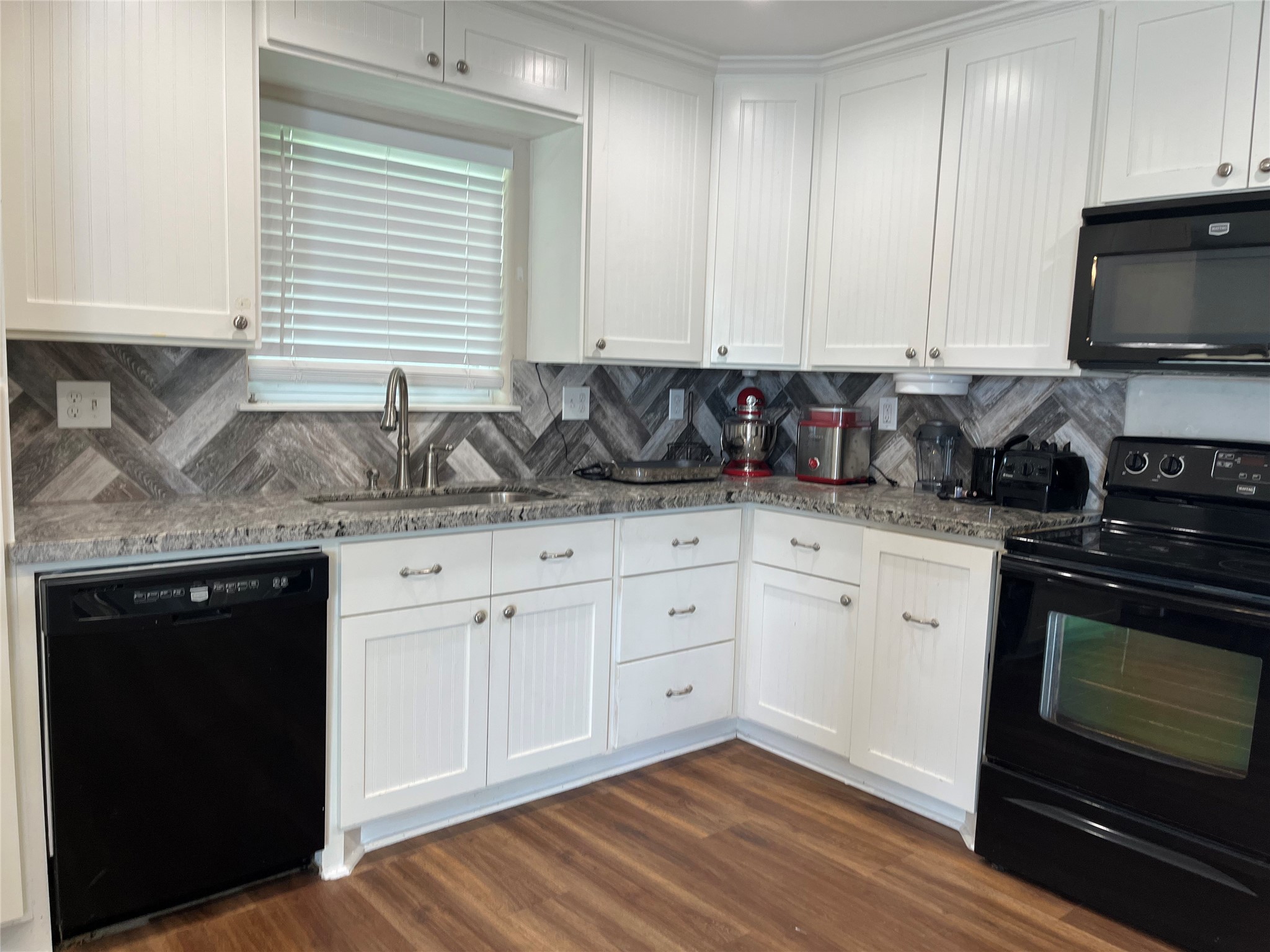 21511 Rio Villa Drive Houston, TX 77049 - Photo 29 of 45 a kitchen with stainless steel appliances granite countertop a sink a stove and a microwave