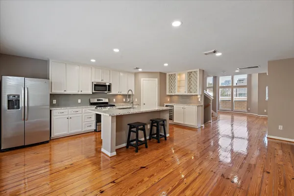 a kitchen with a refrigerator and a microwave