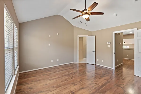wooden floor in an empty room with a window