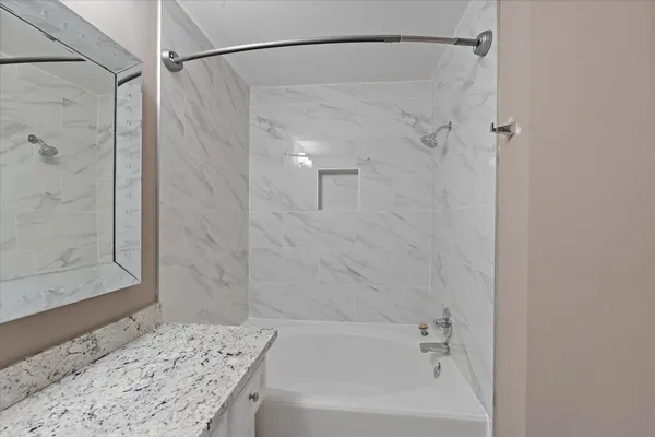 a bathroom with a shower and a bath tub