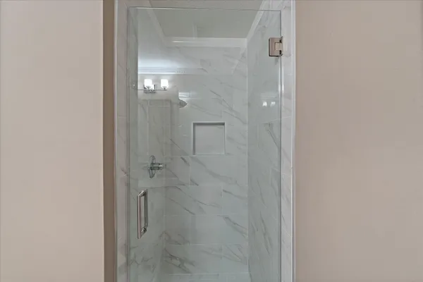 a bathroom with a glass shower door