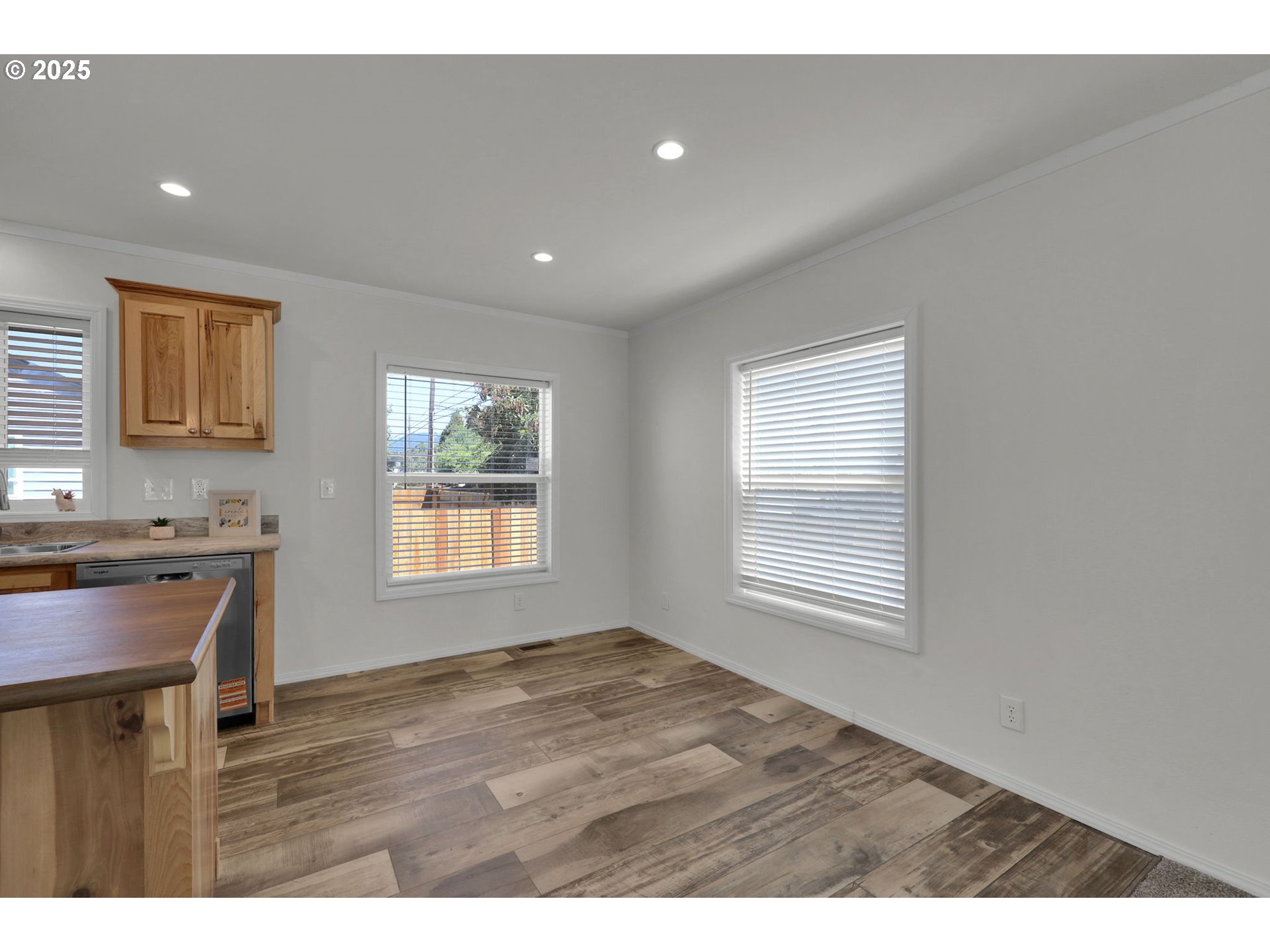 498 Moffit Lane Springfield, OR 97477 - Photo 6 of 24 a view of an empty room with a window and wooden floor