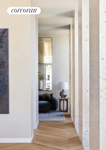 a living room with a balcony a bed and a large window