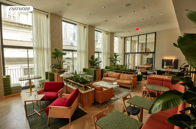 a living room with furniture a rug and a floor to ceiling window