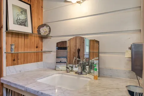 a view of a bedroom with wooden floor and chair