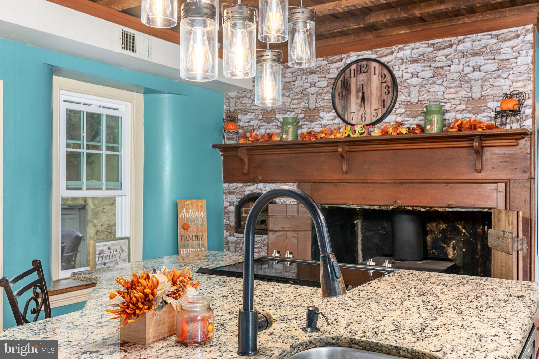 4701 Edges Mill Road Downingtown, PA 19335 - Photo 5 of 55 a view of a fireplace and a table in a patio