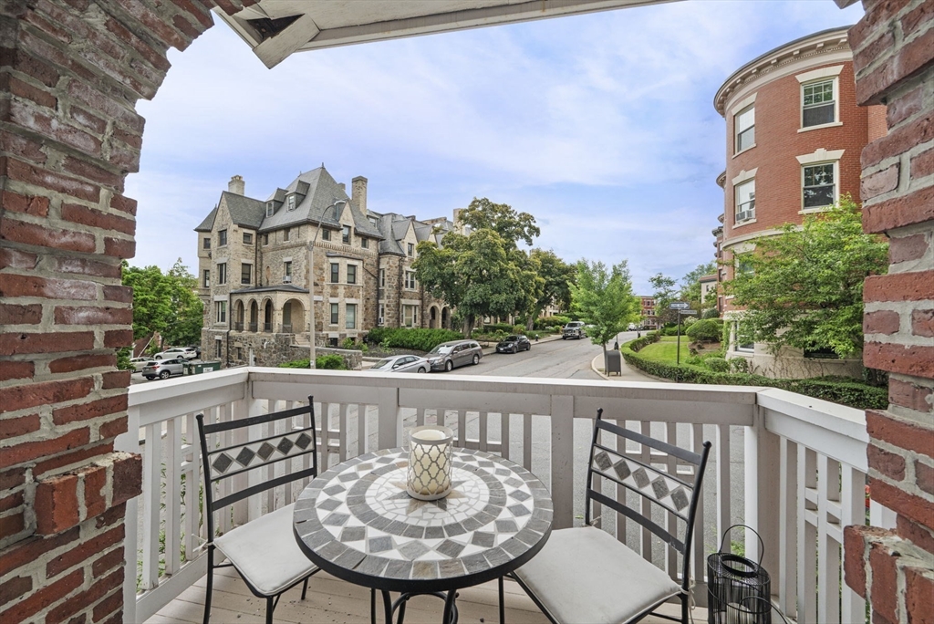 a view of a chairs and table in the balcony