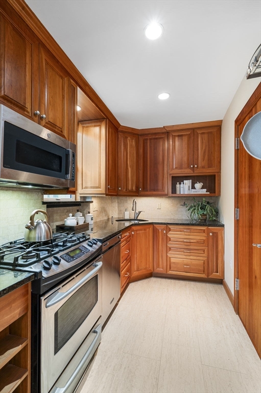 34 Garrison Road, Unit 2 Brookline, MA 02445 - Photo 14 of 21 a kitchen with stainless steel appliances granite countertop a stove a sink and a microwave