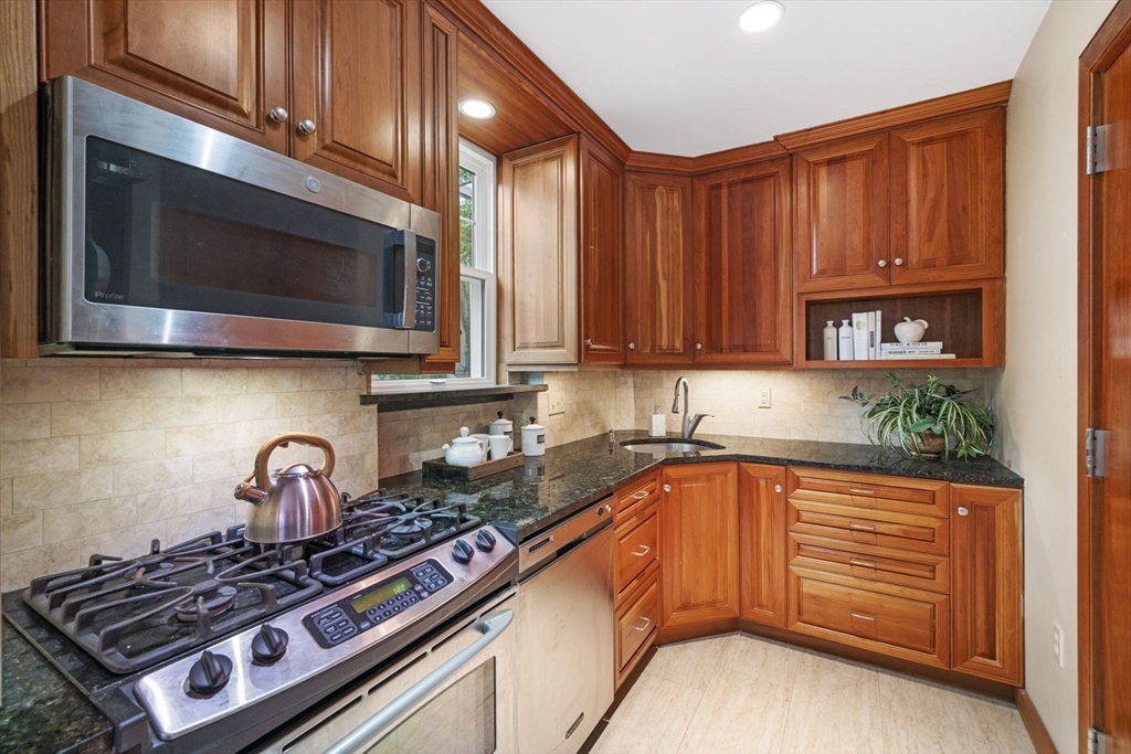 34 Garrison Road, Unit 2 Brookline, MA 02445 - Photo 15 of 21 a kitchen with granite countertop a stove and a microwave