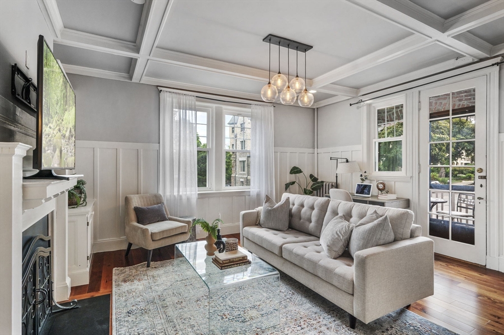 34 Garrison Road, Unit 2 Brookline, MA 02445 - Photo 2 of 21 a living room with furniture a chandelier and a fireplace