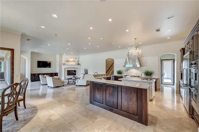 a view of kitchen with stainless steel appliances granite countertop living room and living room