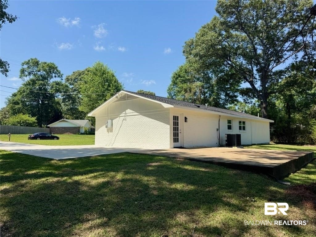 9570 Melanie Lane Semmes, AL 36575 - Photo 8 of 8 Back of house with central AC unit and brick siding