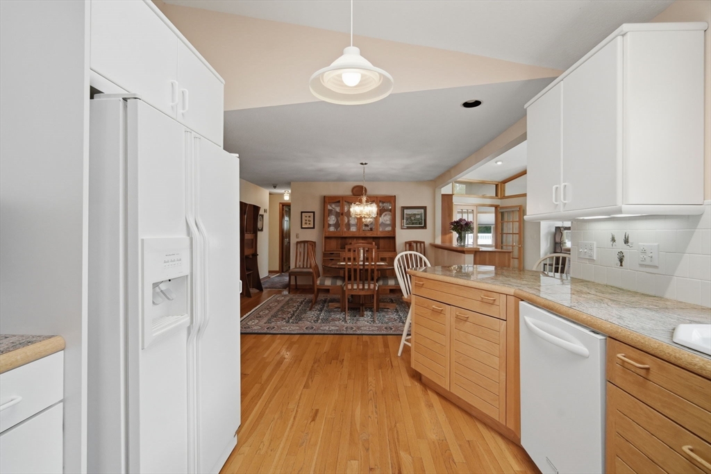 30 Birch Hill Road Northampton, MA 01062 - Photo 11 of 42 a kitchen with stainless steel appliances granite countertop a refrigerator a sink dishwasher a stove and white cabinets with wooden floor
