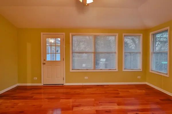 a living room with stainless steel appliances furniture a rug and a kitchen view