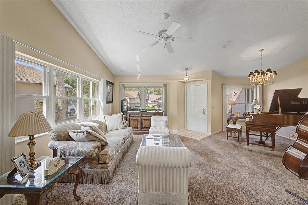 2662 Appleleaf Court Spring Hill, FL 34606 - Photo 6 of 47 a living room with furniture a chandelier and a dining table
