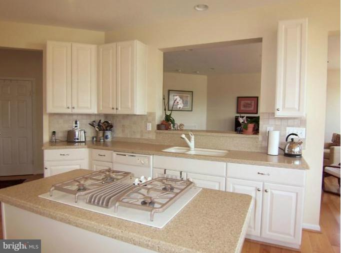 6613 Pebble Brooke Road Baltimore, MD 21209 - Photo 9 of 28 Corian kitchen counters, crisp white cabinetry
