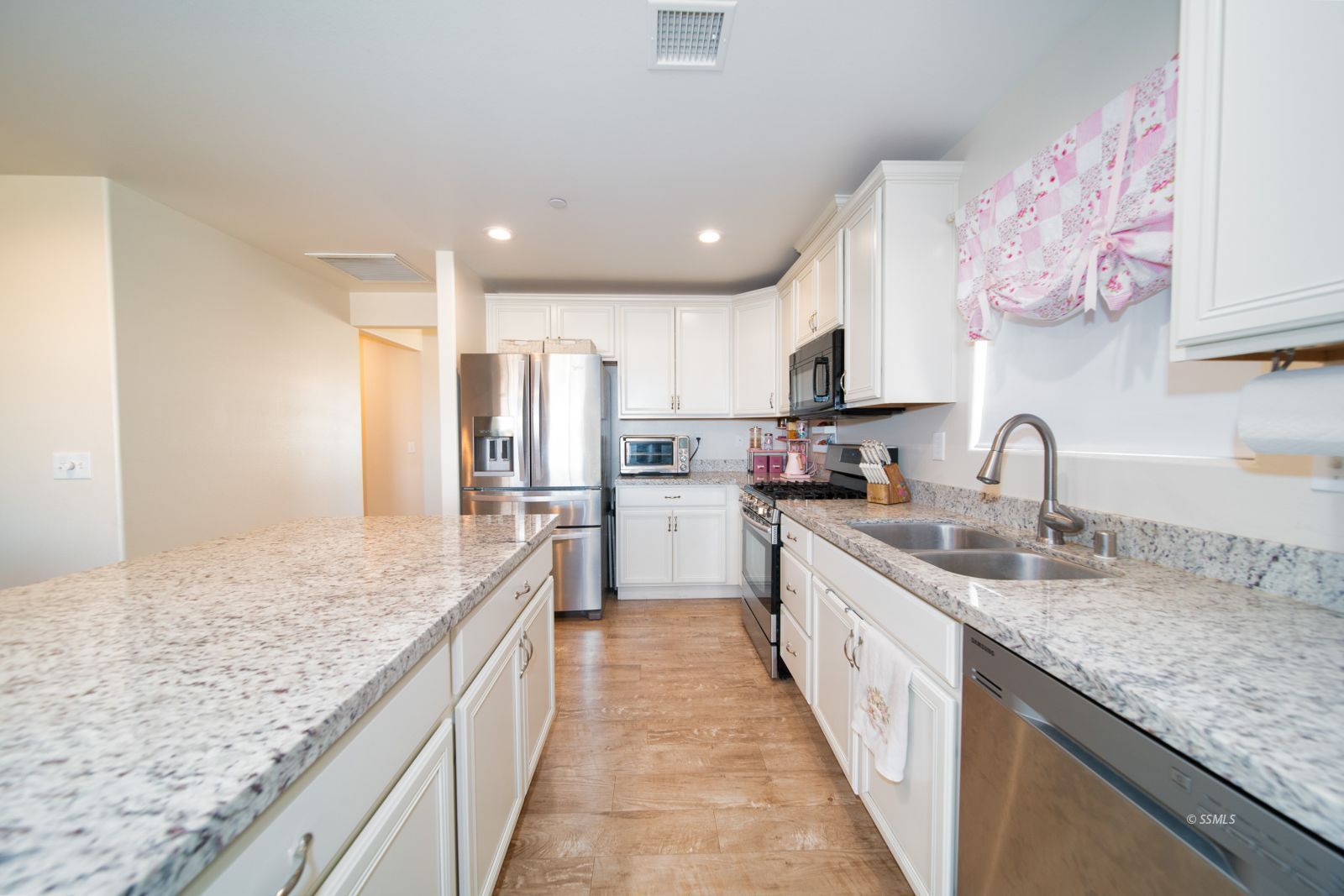 1540 Mayo Street Ridgecrest, CA 93555 - Photo 10 of 32 a large kitchen with kitchen island granite countertop a sink counter space stainless steel appliances and cabinets