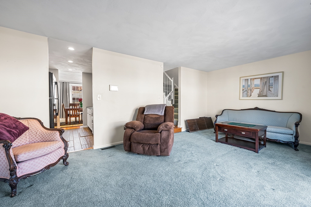 176 Patrick Road, Unit 176 Tewksbury, MA 01876 - Photo 11 of 42 a living room with furniture and a couch