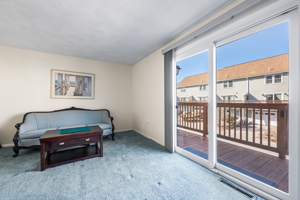 176 Patrick Road, Unit 176 Tewksbury, MA 01876 - Photo 13 of 42 a living room with furniture