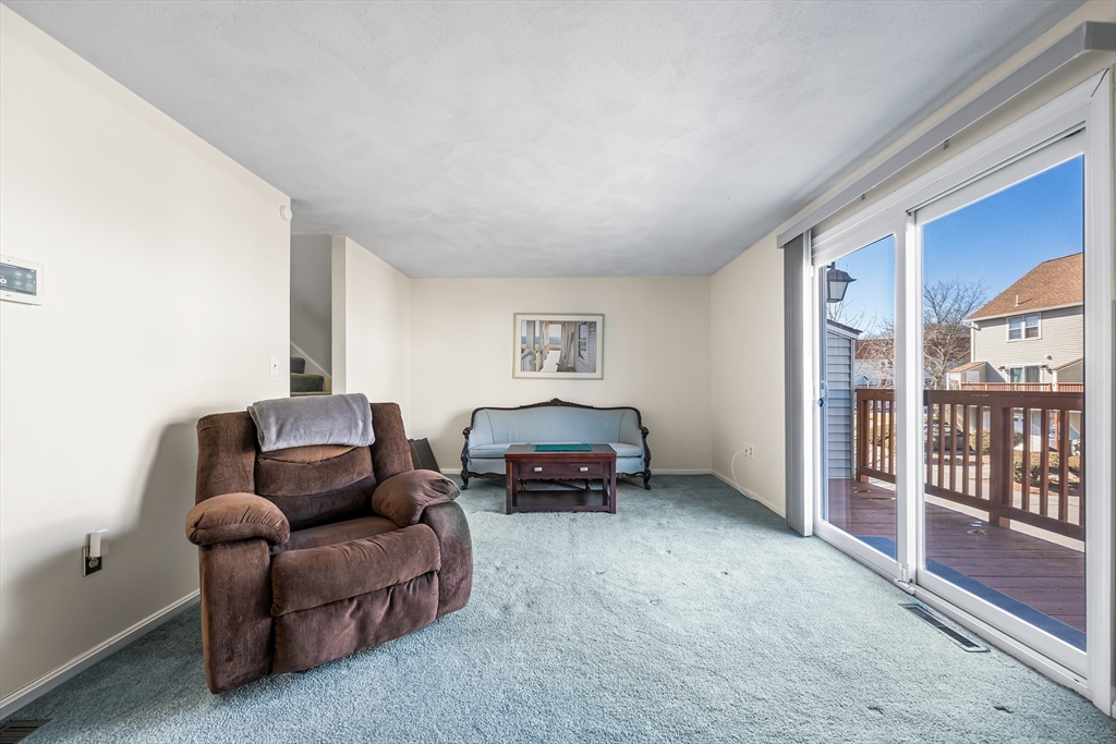 176 Patrick Road, Unit 176 Tewksbury, MA 01876 - Photo 14 of 42 a living room with furniture