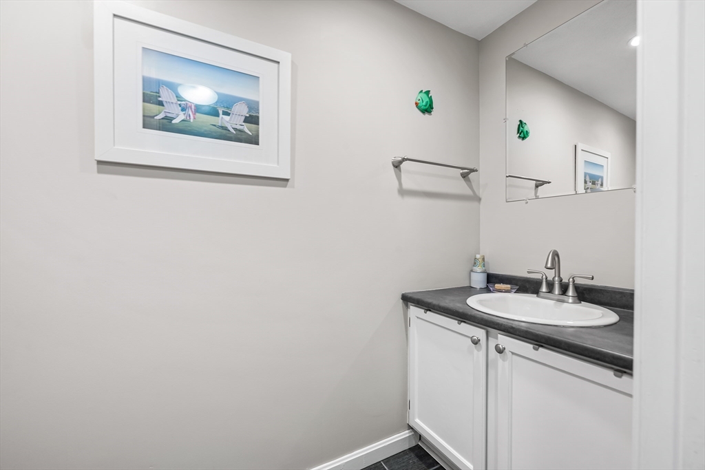176 Patrick Road, Unit 176 Tewksbury, MA 01876 - Photo 18 of 42 a bathroom with a granite countertop sink a mirror and vanity