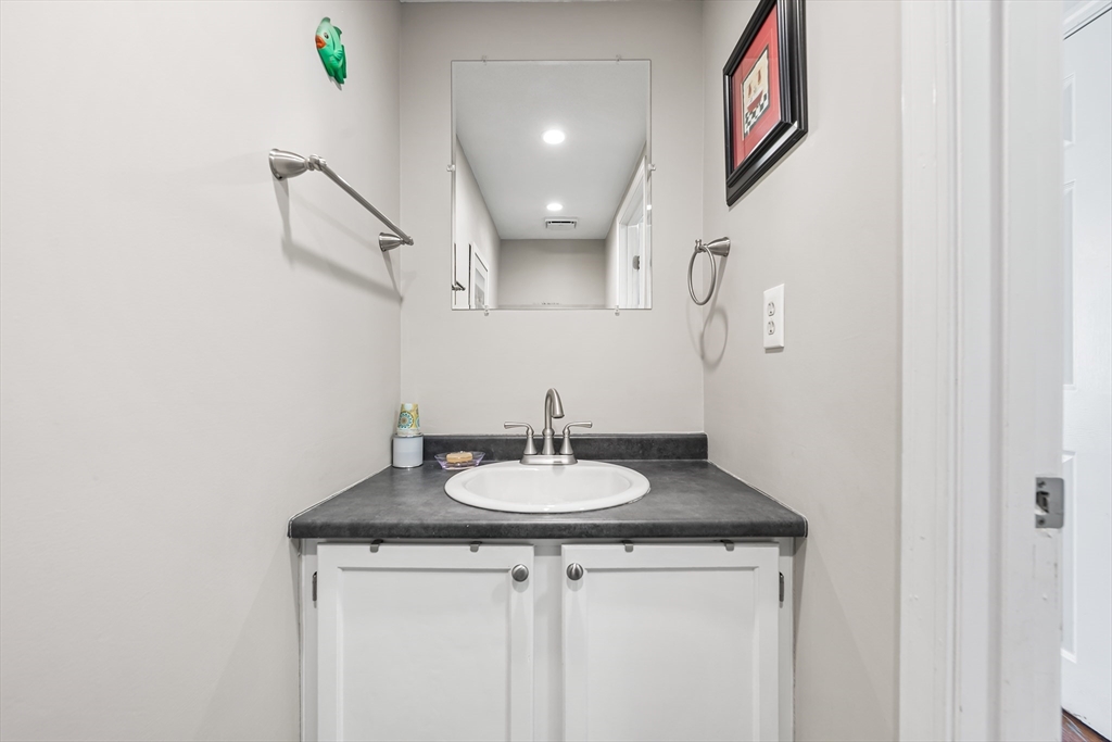176 Patrick Road, Unit 176 Tewksbury, MA 01876 - Photo 19 of 42 a bathroom with a sink and a mirror