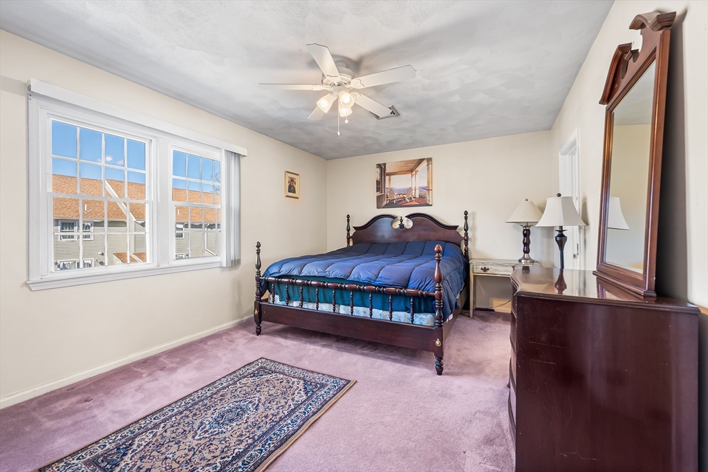 176 Patrick Road, Unit 176 Tewksbury, MA 01876 - Photo 21 of 42 a bedroom with a bed and window