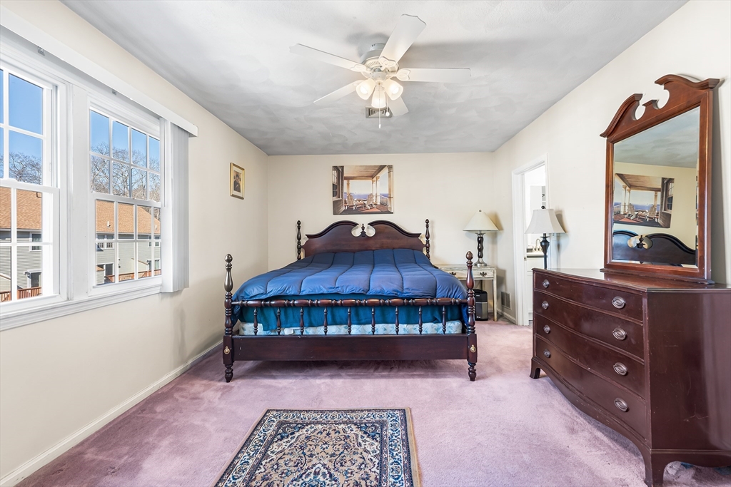 176 Patrick Road, Unit 176 Tewksbury, MA 01876 - Photo 22 of 42 a living room with furniture and a window