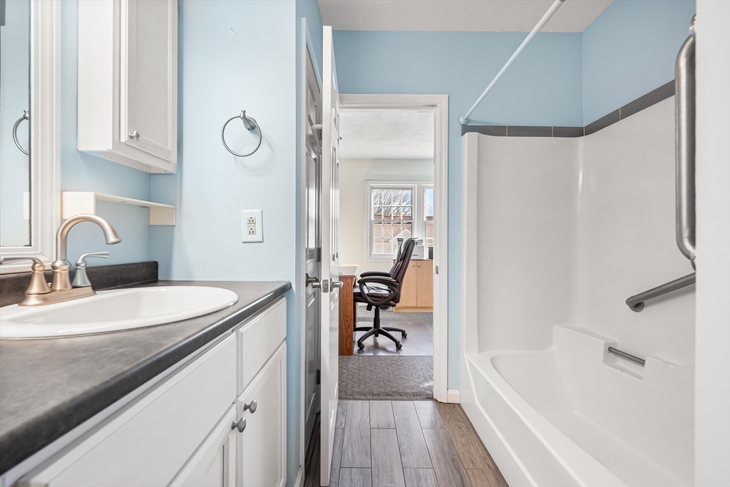 176 Patrick Road, Unit 176 Tewksbury, MA 01876 - Photo 26 of 42 a spacious bathroom with a tub sink and mirror