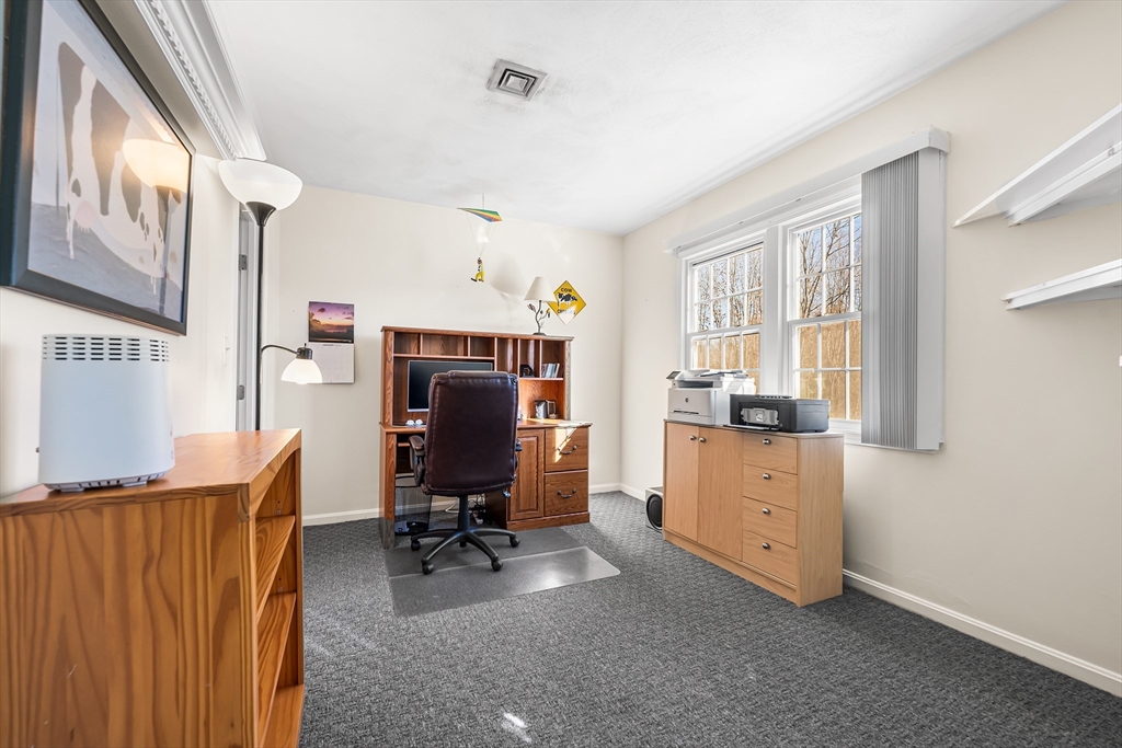 176 Patrick Road, Unit 176 Tewksbury, MA 01876 - Photo 27 of 42 a view of a workspace with furniture and a window