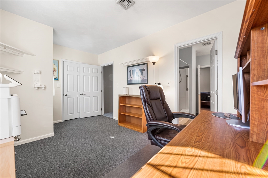176 Patrick Road, Unit 176 Tewksbury, MA 01876 - Photo 28 of 42 a view of a workspace with furniture and a window