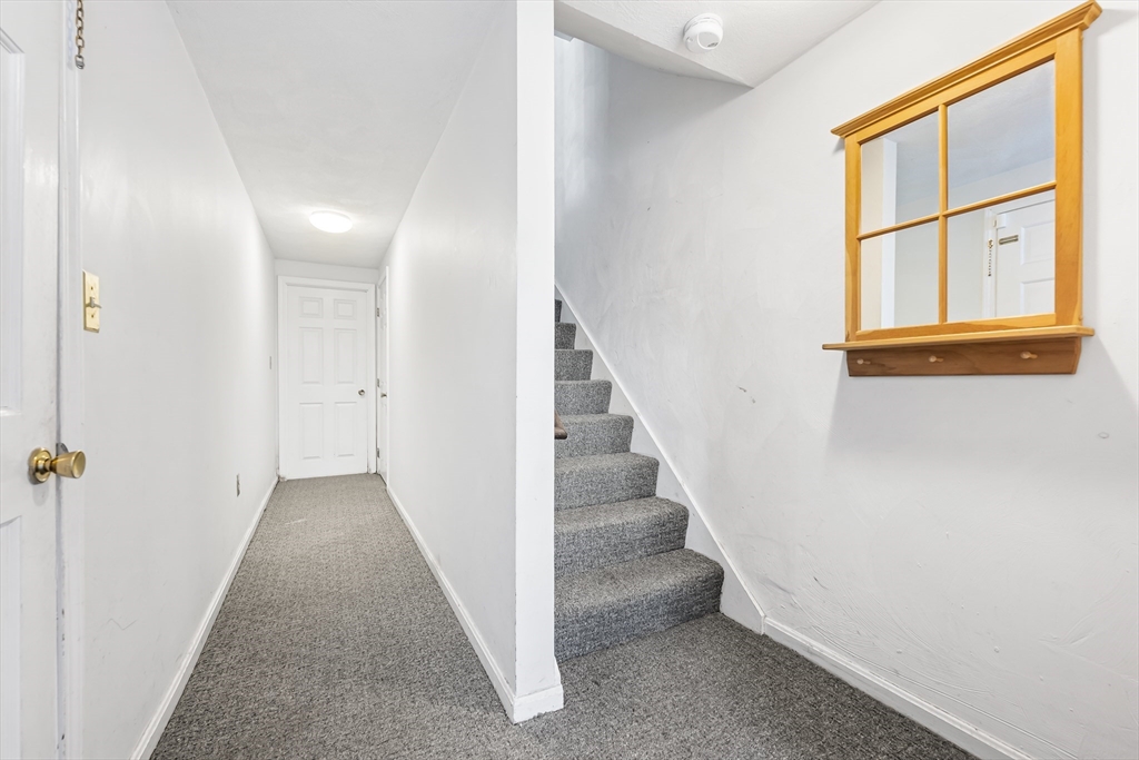 176 Patrick Road, Unit 176 Tewksbury, MA 01876 - Photo 30 of 42 a view of a hallway with wooden floor and entryway