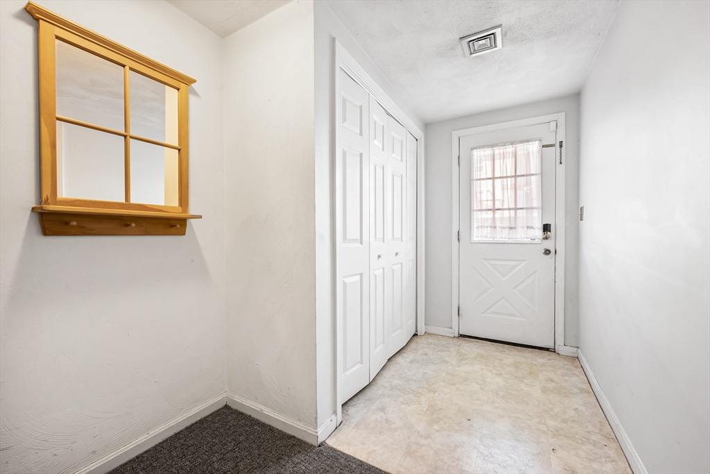 176 Patrick Road, Unit 176 Tewksbury, MA 01876 - Photo 31 of 42 an empty room with windows