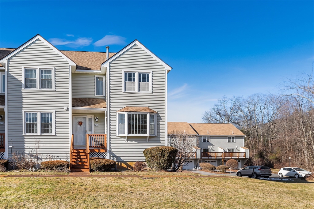 176 Patrick Road, Unit 176 Tewksbury, MA 01876 - Photo 33 of 42 a front view of a house with a yard